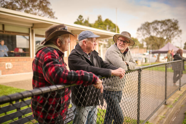 Three men chatting outdoors