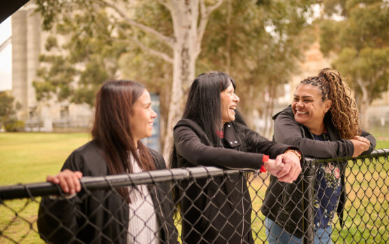 Three First Nations women chatting outdoors