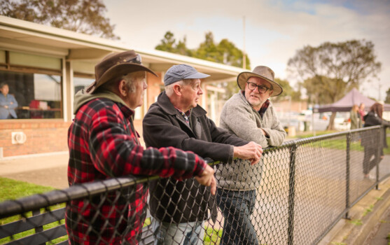 Three men chatting outdoors